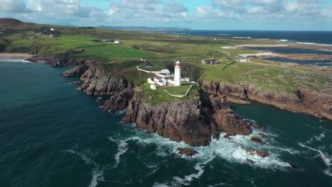 Fanad-Head-Lighthouse,-aerial-view,-landmark-or-Donegal-county,-Ireland,-scenic-coastlike-and-sea-cliffs,-drone-shot