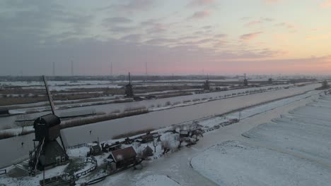 Serene-morning-sunrise-at-winter-landscape-of-rural-Dutch-windmills