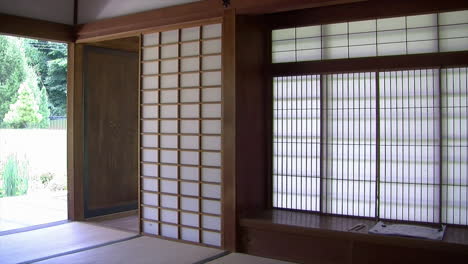 Pan-from-shoin-desk-and-interior-of-Japanese-house-to-view-of-pond-and-garden