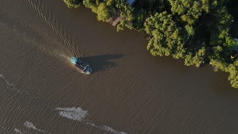 Aerial-birds-eye-shot-of-Brazilian-Cargo-Ship-transporting-wood-trunks-on-calm-Amazon-River-during-sunset