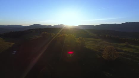 Epic-sunrise-behind-Jura-Mountains-during-blue-sky-and-red-lens-flares