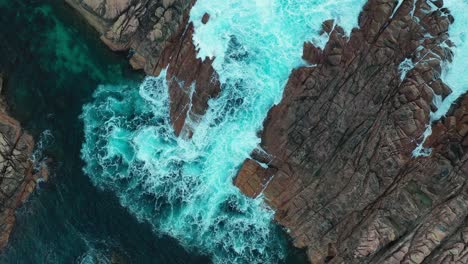Canal-Rocks,-Leeuwin-Naturaliste-National-Park,-Australia,-Birdseye-Aerial-View-of-Unique-Coastal-Rock-Formation-and-Ocean-Waves,-Top-Down-Drone-Shot