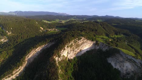 Aerial-birds-eye-shot-of-Belvedere-de-la-Roche-Blanche-mountain-during-spring-season-and-in-background-Monts-Jura-and-Cret-de-Chalam
