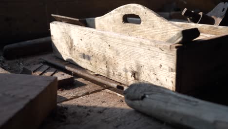 Old-wooden-toolbox-on-worktop-illuminated-by-sunlight