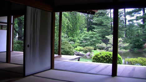 Pan-from-interior-of-Japanese-house-to-view-of-garden-and-koi-pond