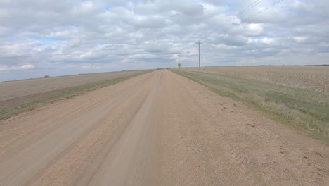 Point-of-view-driving-on-a-gravel-road-and-thru-and-railroad-crossing