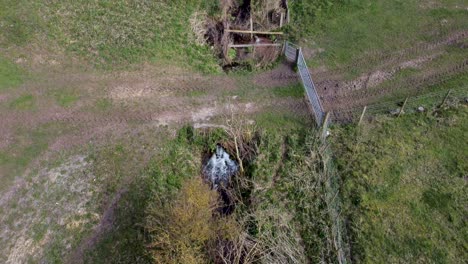 Drone-Aerial-view-of-a-stream-with-a-meadow