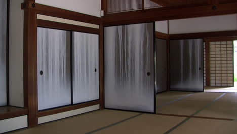 Pan-of-interior-of-Japanese-house-with-painted-fusuma-to-view-of-garden