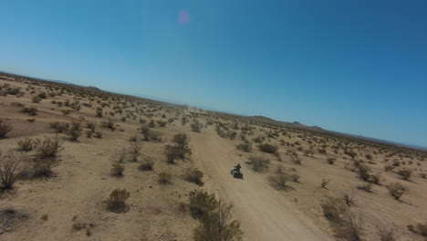Four-wheelers-enjoy-an-exciting-adventure-of-riding-along-the-Mojave-Desert-trails---aerial-view-slow-motion