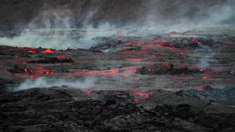 Red-Orange-Molten-Lava-Flowing-On-Lava-Field-With-Smoke