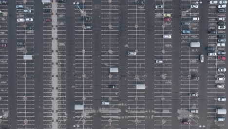 AERIAL:-Very-High-Flight-Over-Almost-Empty-Parking-Space-Lot