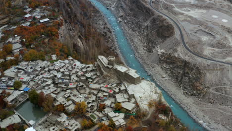 Aerial-of-Altit-fort-and-the-Karakora-Highway-along-the-Hunza-river,-Pakistan