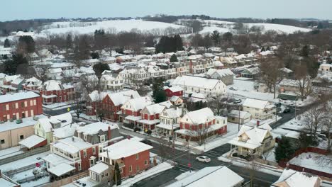 Descending-aerial-on-small-American-town-covered-in-winter-snow
