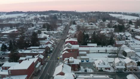 Aerial-truck-shot-of-small-town-in-USA,-covered-in-winter-snow
