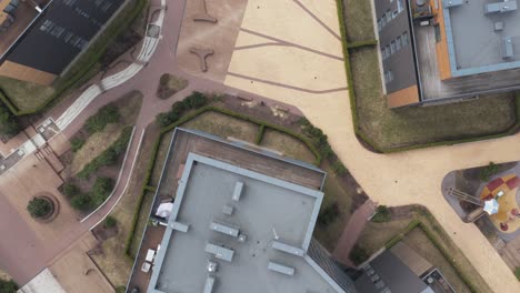 AERIAL:-Flying-Over-Modern-Very-Colourful-Buildings-with-Playgrounds