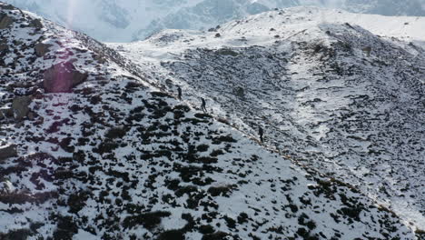 Hikers-climbing-snowy-mountain-towards-Nanga-Parbat-basecamp,-Himalaya