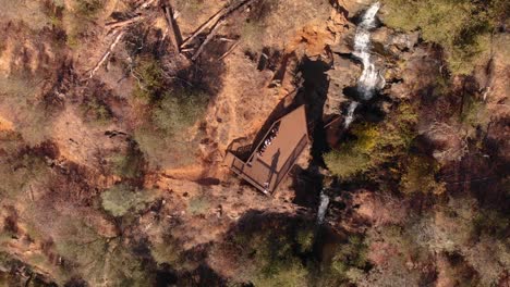 Aerial-view-of-Hidden-Falls-Regional-Park-waterfall-flowing-through-the-Auburn,-California-mountains