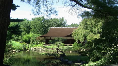 Long-shot-of-a-traditional-Japanese-house-with-surrounding-garden-and-pond