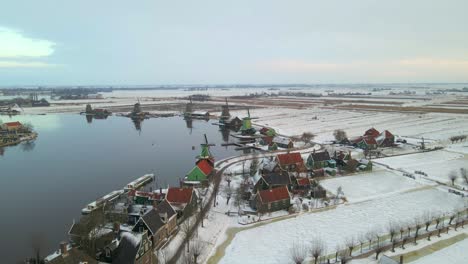 Winter-season-in-Netherlands-with-flat-land-and-famous-Windmills-at-Zaan-river
