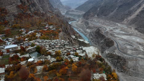 Aerial-circling-above-ancient-Altit-fort,-Hunza-Valley-in-autumn-colors