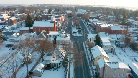Aerial-dolly-shot-approaching-town-square-in-winter-snow