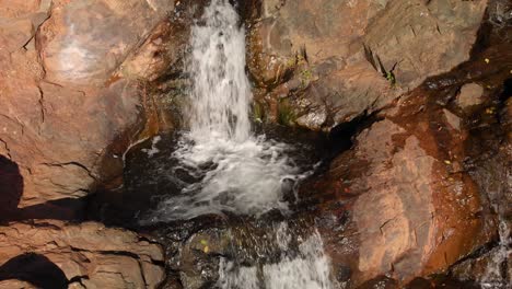 Close-up-of-Hidden-Falls-Regional-Park-waterfall-and-creek-flowing-through-the-Auburn,-California-mountains