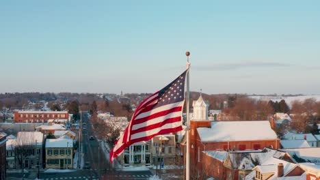 Aerial-of-American-flag-in-winter-snow