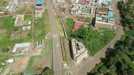 Aerial-drone-view-overlooking-cars-on-the-streets-of-the-Oloitokitok-village,-in-Kenya
