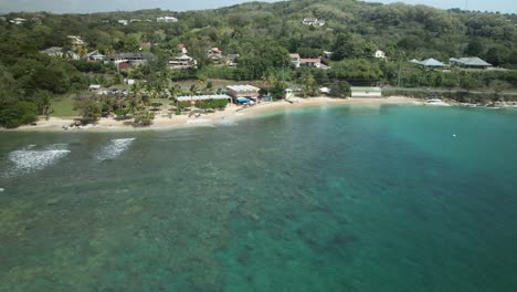 Ascending-aerial-of-waves-breaking-on-the-shallow-reef-of-Mt-Irvine-Bay-located-on-the-Caribbean-island-of-Tobago