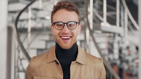close-up-portrait-of-a-curly-smiling-man-with-glasses