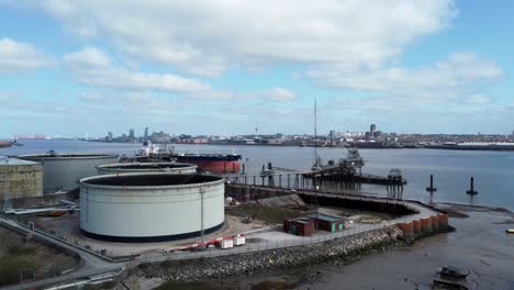 British-industrial-crude-oil-distribution-pipeline-terminal-aerial-rising-view-across-shipping-refinery