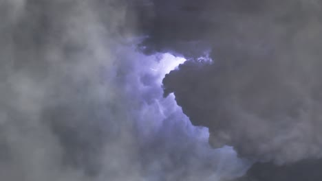 a-thunderstorm-that-is-going-on-in-thick-clouds-with-a-thunderbolt,-zoom-in