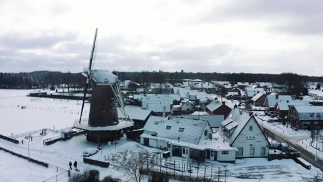 Aerial-View-of-Winter-Scenery-in-Dutch-Countryside,-Windmill-and-Village-Houses