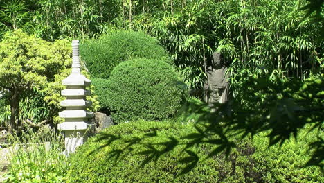 Stone-pagoda-and-Buddhist-statue-of-Jizo-in-a-Japanese-garden