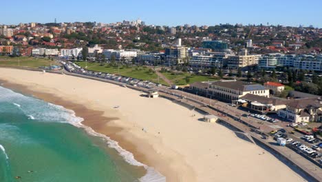Scenery-Of-Uncrowded-Bondi-Beach,-In-View-Is-Sydney-Cityscape-In-New-South-Wales,-Australia-During-Daytime---aerial-drone-shot