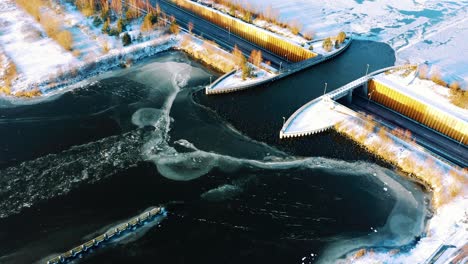 Aerial-View-of-Veluwemeer-Aqueduct,-Harderwijk,-Netherlands,-Road-Traffic,-Water-Bridge,-Frozen-Lake-and-White-Winter-Landscape,-Drone-Shot