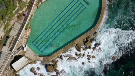The-Bronte-Baths---A-Popular-Ocean-Filled-Swimming-Pool-At-Bronte-Beach-In-Sydney,-New-South-Wales,-Australia---aerial-top-down