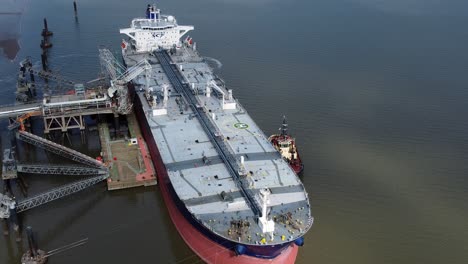 Crude-oil-tanker-ship-loading-at-refinery-harbour-terminal-aerial-view-orbit-right