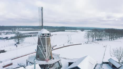 Aerial-Winter-Day-Scene,-Snow-Covered-Windmill-in-Garderen,-Netherlands