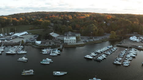 Beautiful-Aerial-sunset-shot-of-a-boatyard-on-the-Royal-River-in-Yarmouth,-Maine-during-autumn