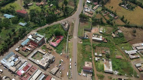 Aerial-view-of-cars-and-people-at-a-Open-Air-Market,-in-Africa---reverse,-drone-shot