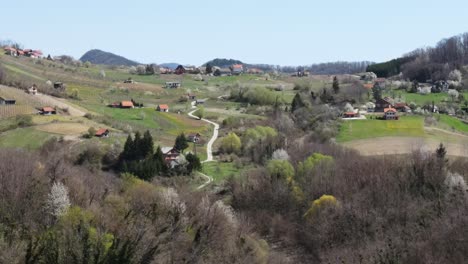 Beautiful-countryside-on-a-sunny-Spring-day,-with-rolling-hills-and-doted-villages