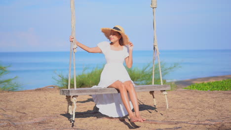Carefree-Asian-Woman-on-Big-Swing,-Seascape-Sunny-Background-SLOMO