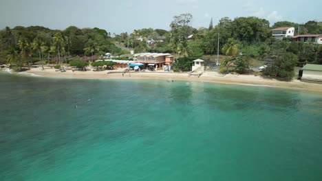 Aerial-view-of-an-amazing-beach-and-beach-bar-at-Mt-Irvine-Bay,-Tobago