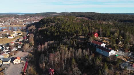 Rural-Open-Air-Museum-named-Gammelgarden-In-Bengtsfors-City-In-Sweden,-aerial-view-during-sunny-day
