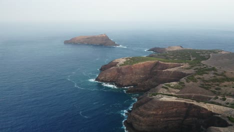 Scenic-volcanic-coast-of-Porto-Santo-with-Ilhéu-de-Ferro-island,-aerial