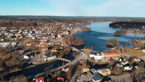 Bird's-Eye-View-Of-Bengtsfors-Along-Dalsland-Canal-In-Vastra-Gotaland,-Sweden-With-Buildings-And-Trees-On-A-Sunny-Day