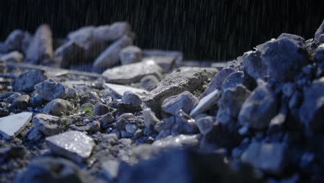 Evening-Thunderstorm-Raindrops-falling-on-rocky-debris-surface-close-up-smooth-moving-macro-dolly
