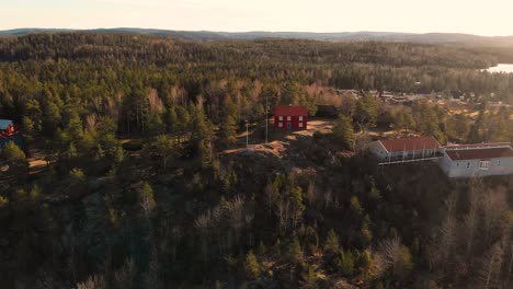 Aerial-flyover-Gammelgarden-Open-Air-Museum-in-Bengtsfors-during-sunset