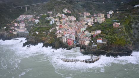 Aerial-view-of-Riomaggiore,-Cinque-Terre,-during-a-sea-storm
